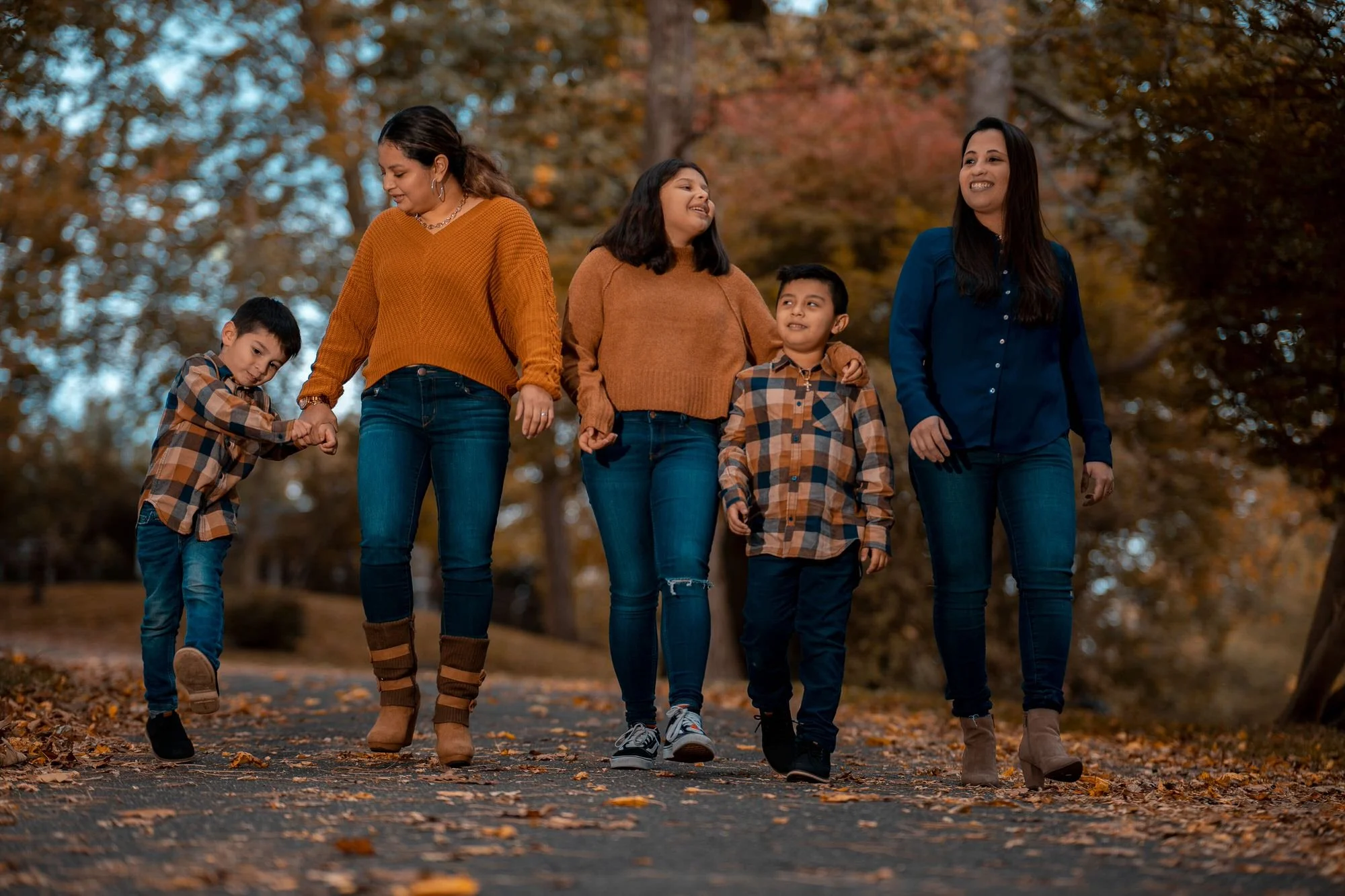 A family walks through the woods together.