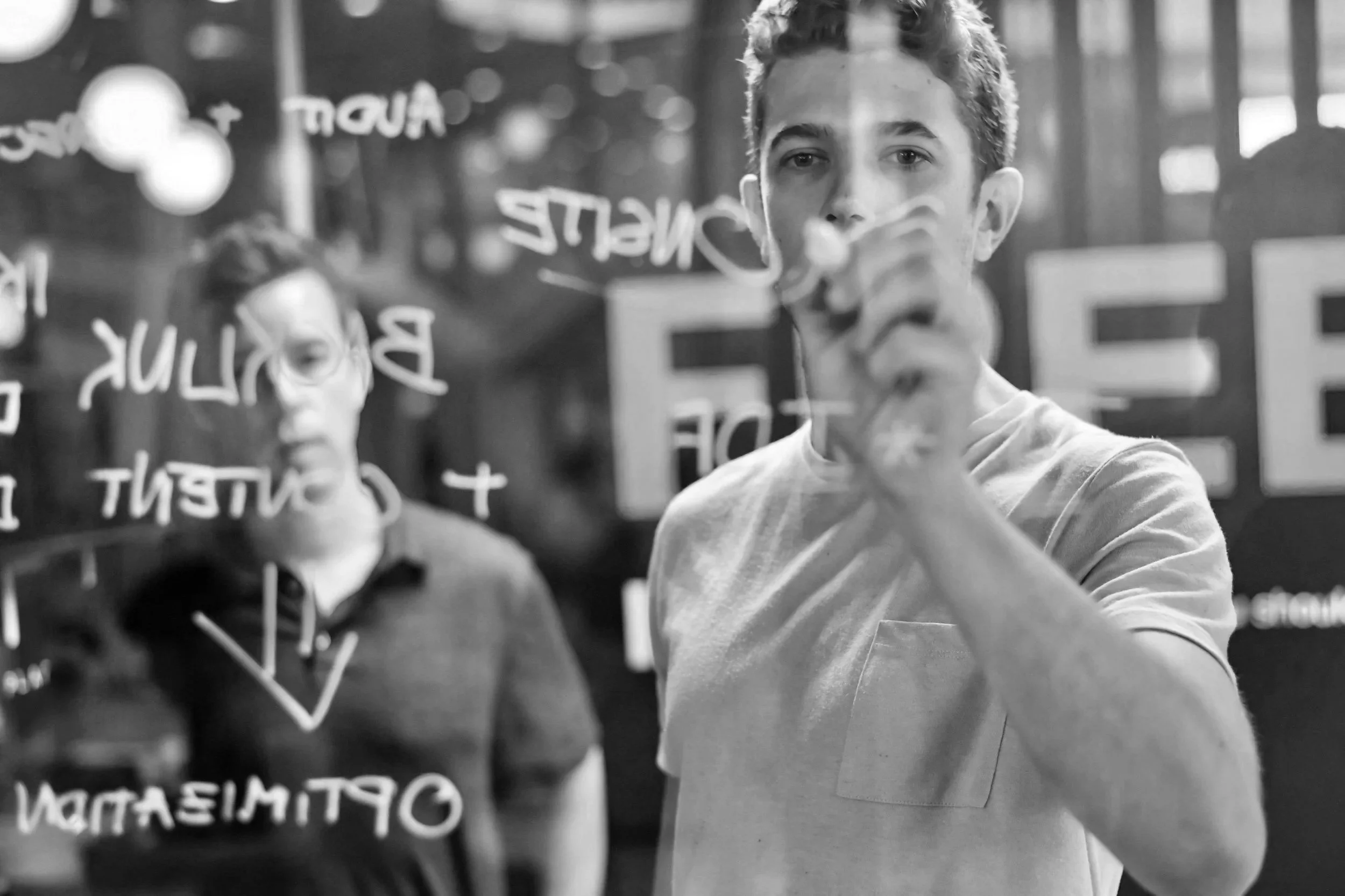 Marketing strategist mapping a customer journey on a glass board