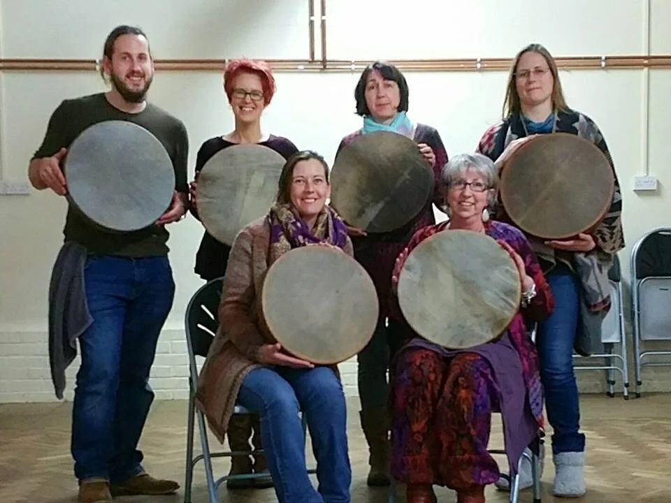Group of six people holding newly birthed Shamanic Drums from a workshop in Ashford, Kent, UK