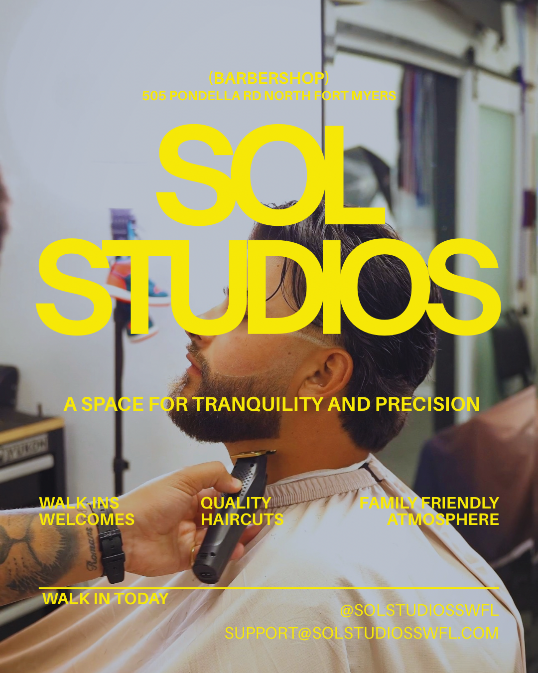 Sign for Sol Studios barbershop at 505 Pondella Road, North Fort Myers with a barber giving a haircut to a customer in the background.
