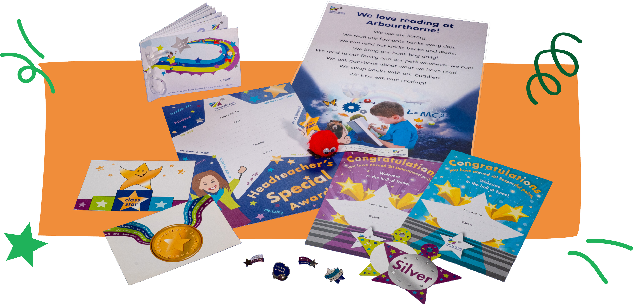 School awards display includes certificates, medals, and certificates for reading, classroom star, and headteacher's special award, along with a small red plush toy, all arranged on an orange table with star-shaped decorations.