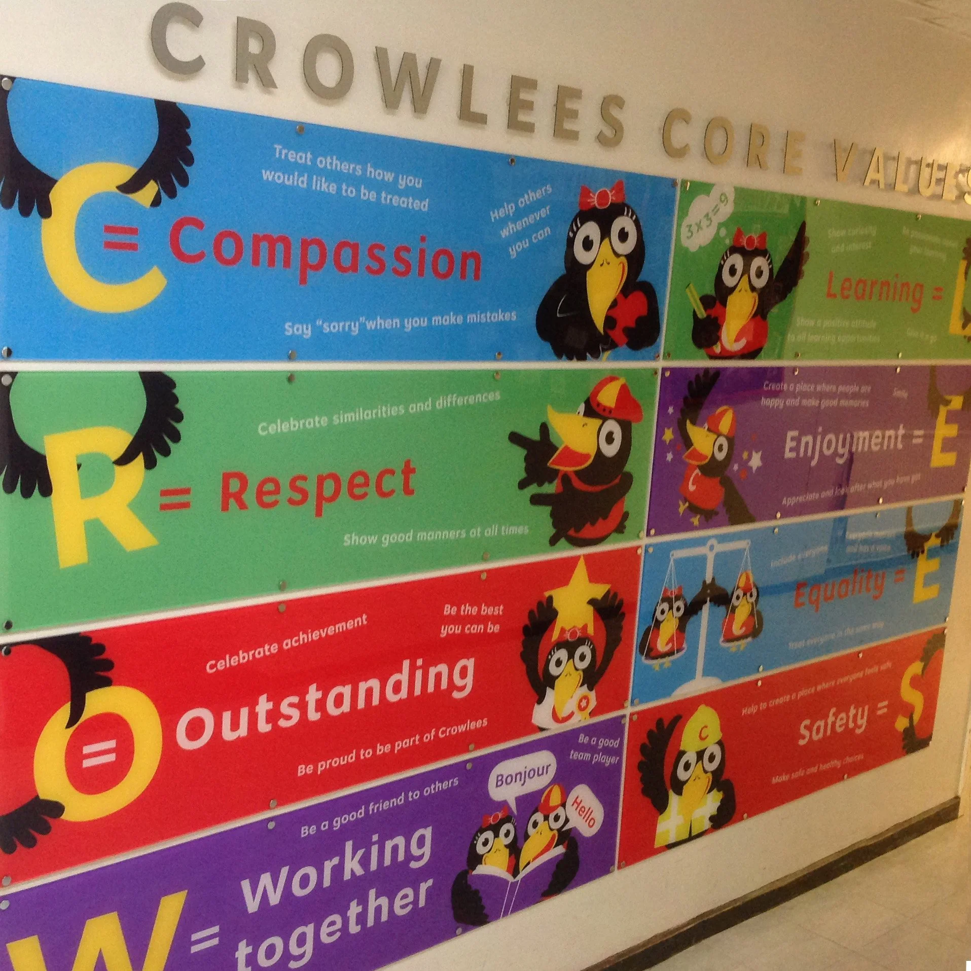 Colorful educational poster about values featuring cartoon crow characters with various traits and messages.