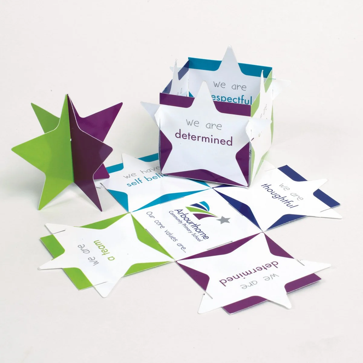 Paper stars with positive affirmations and the Abbeythorne Community Primary School logo.