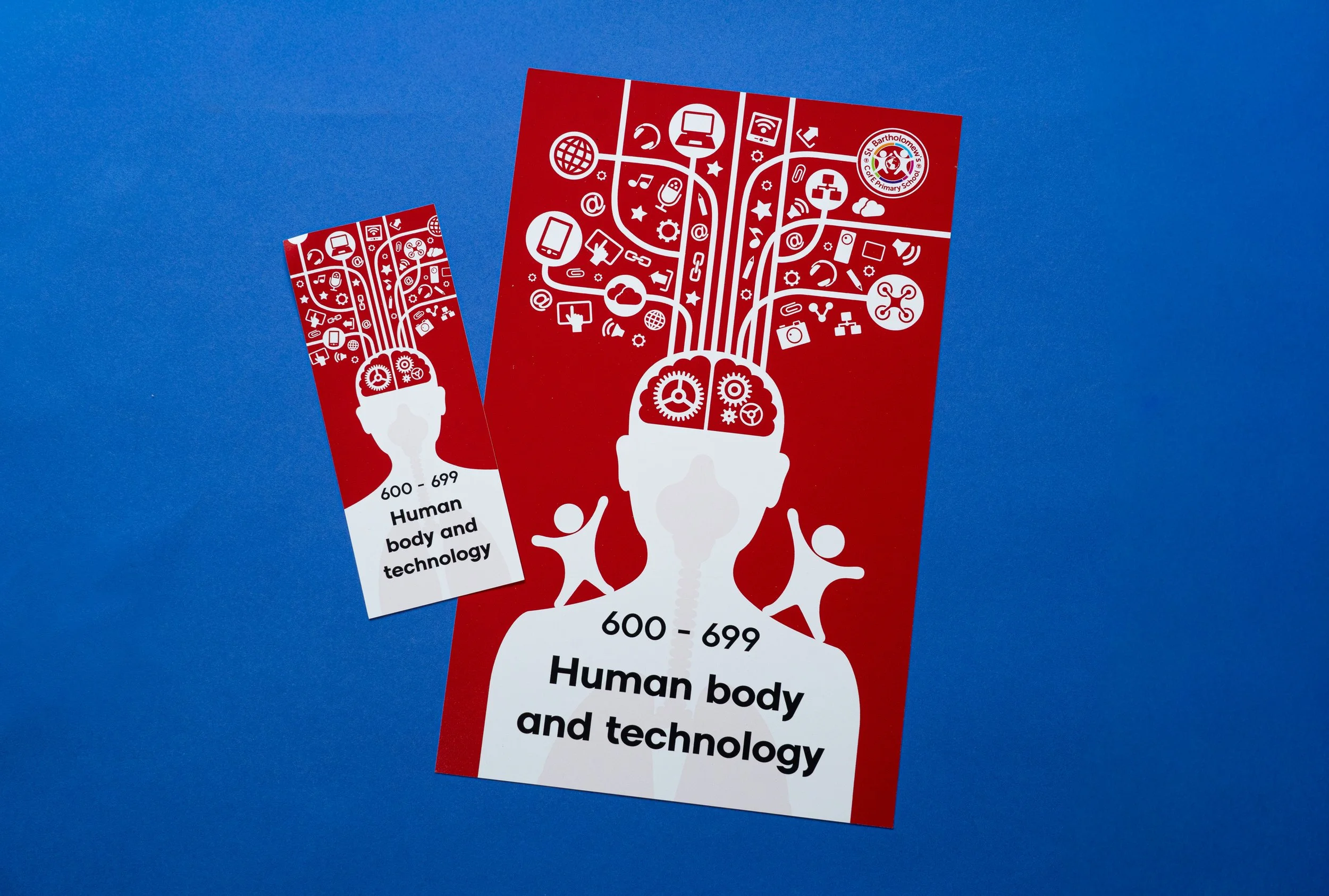 A red informational flyer with white illustrations of technology and human head with gears, the flyer mentions '600-699 Human body and technology' and shows a logo for St. Bartholomew's Church Primary School.