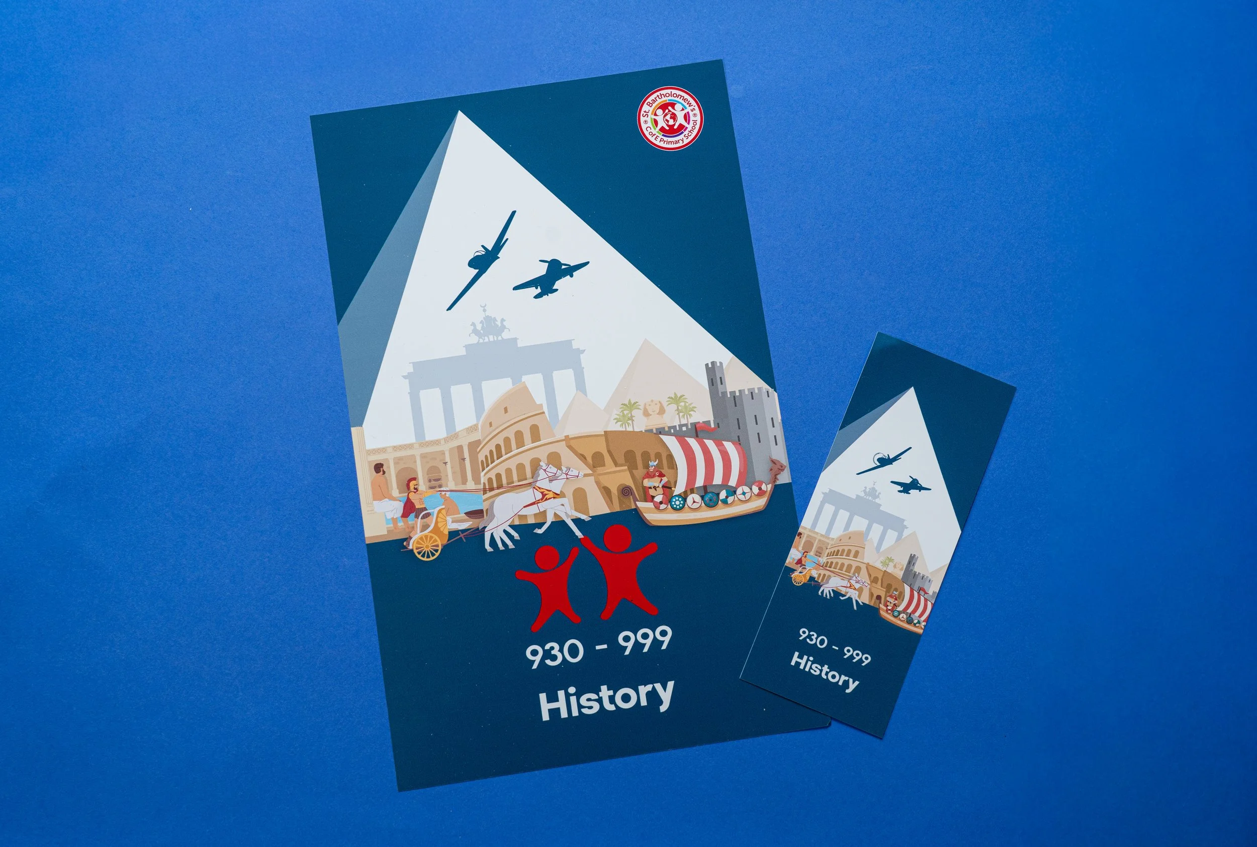 Two brochures titled '930 - 999 History' with colorful illustrations of historic landmarks, ancient Roman chariot race, and flying aircraft, on a blue background.