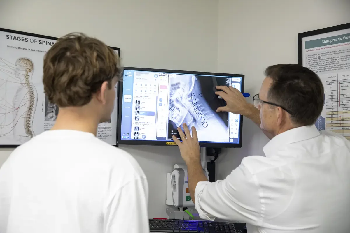 Dr Brett Grant, Chatswood Chiropractor reviewing spinal X-ray