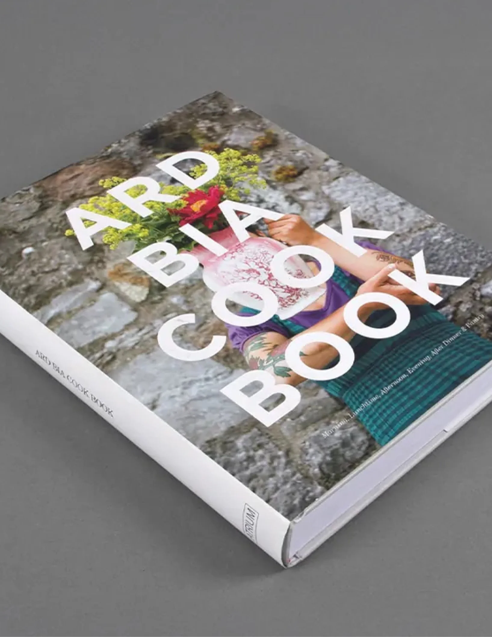 Book cover titled 'Advanced Baby Book' with a person in a purple shirt holding a bouquet of flowers, on a stone surface.