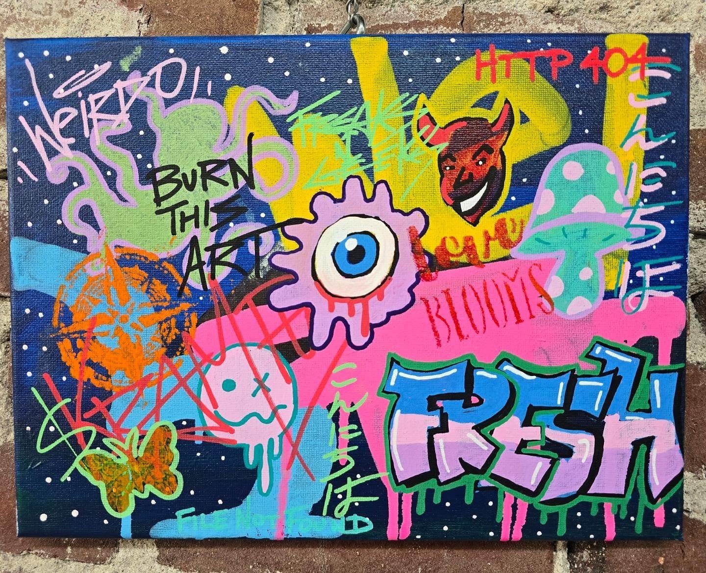 Colorful graffiti mural featuring a central eye design with splashes of pink, purple, yellow, blue, green, orange, and red, including various words like 'Happy Birthday', 'Burn the Art', 'Blues', and 'Fresh', with decorative elements such as a butter