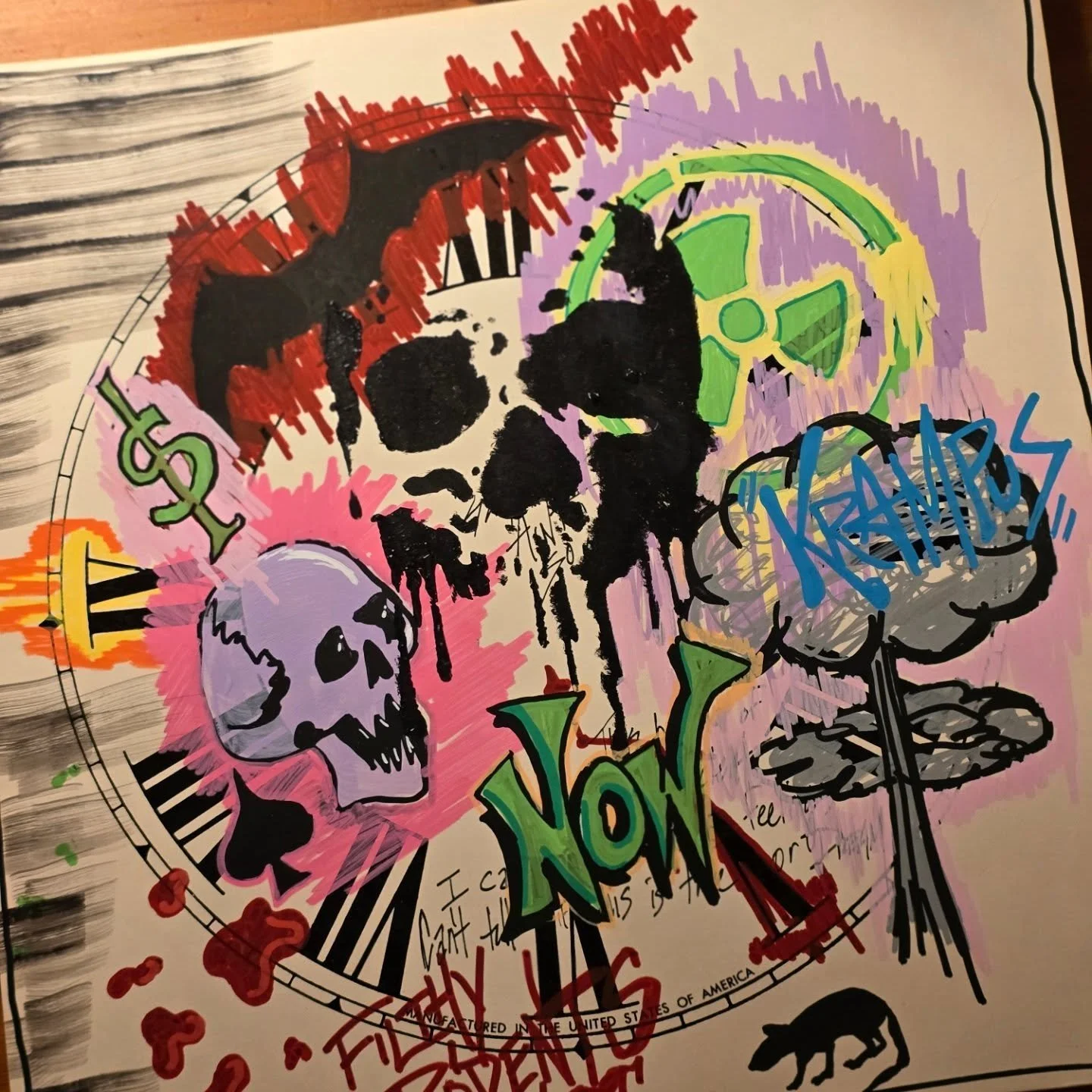 Street art with a black and white skull and various colorful graffiti including the words 'NO' and 'KREAMS'.