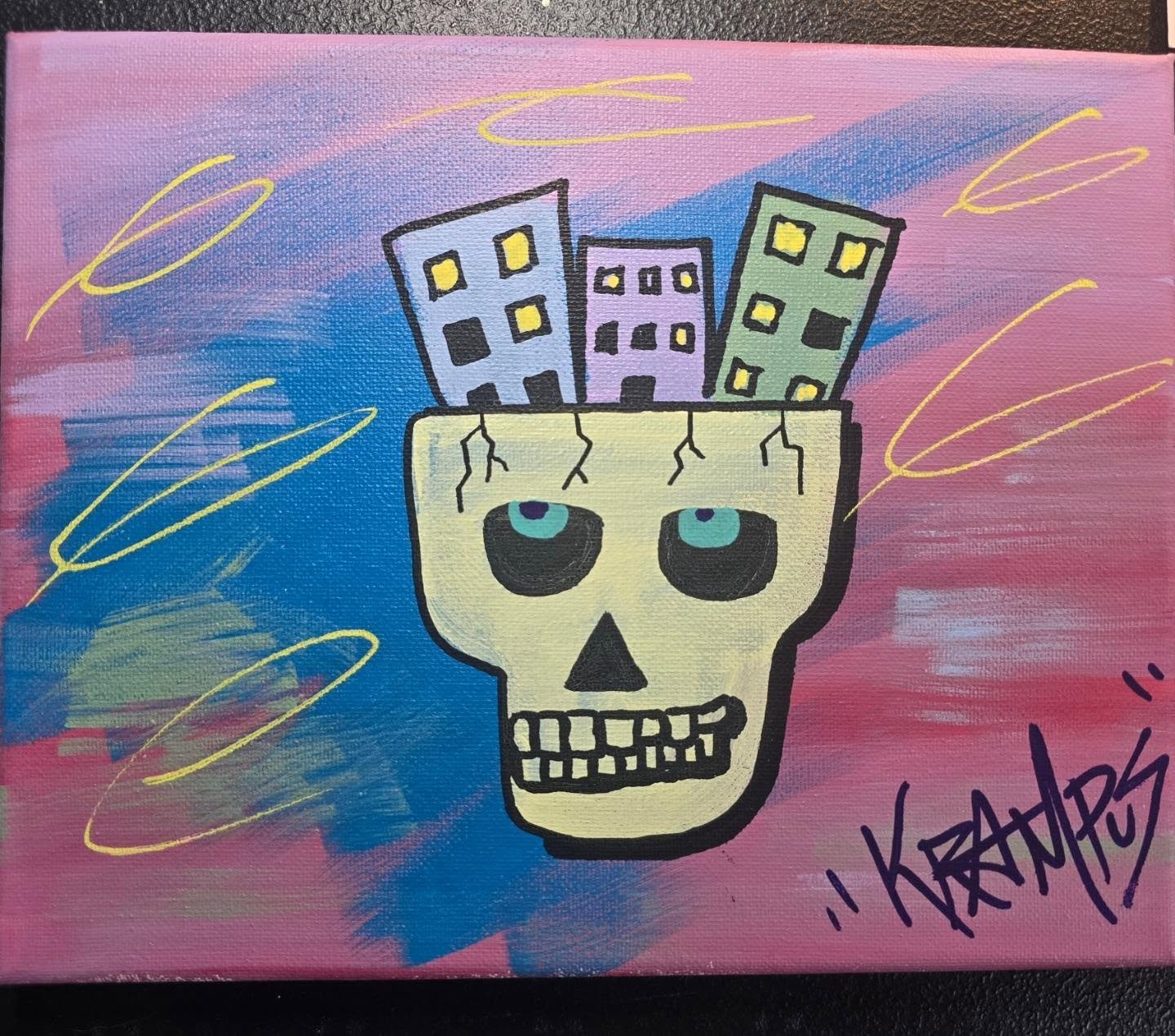 A colorful painting of a skull with three buildings inside the top of the head against a pink and blue background with yellow squiggly lines.