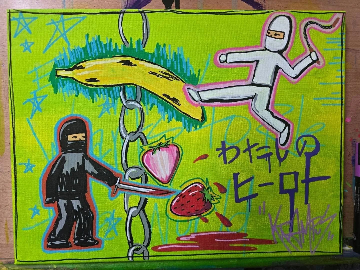 Colorful graffiti-style artwork featuring two ninja figures in black and gray, one holding a sword and the other in a jumping pose. There is a large yellow banana with a chain hanging from the top, a heart and strawberry with a chain connecting to th