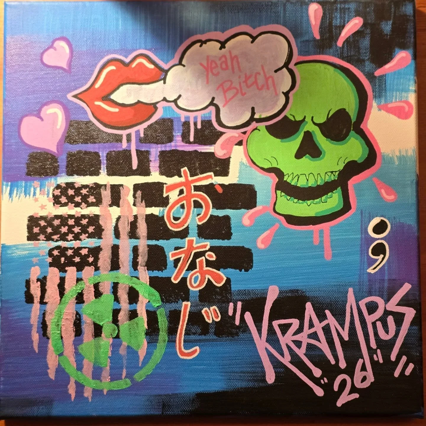 A colorful graffiti-style artwork with a green skull, pink lips with a tongue sticking out, and a speech bubble saying 'Yeah Bitch'. There are pink hearts, a black brick wall background with dripping paint, a pink Japanese character, a peace symbol, 