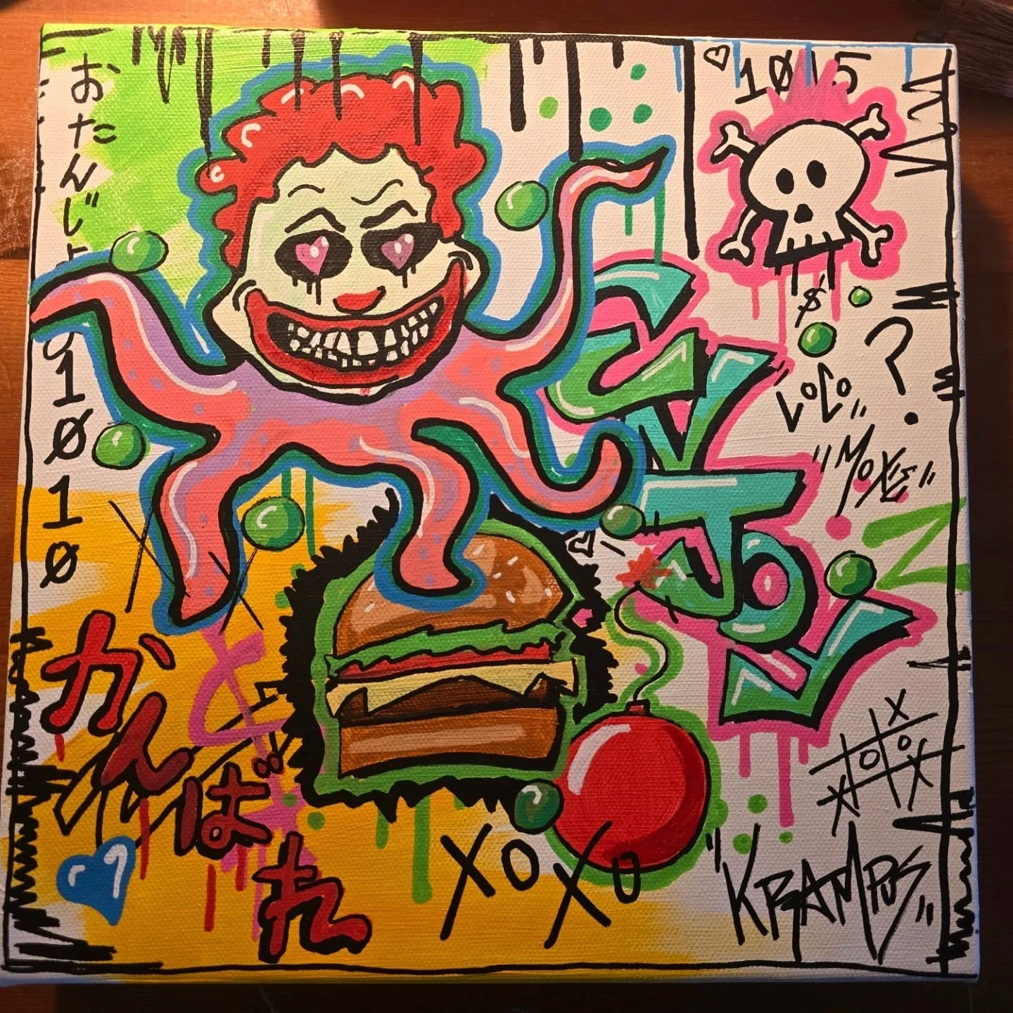 Colorful graffiti-style artwork featuring a cartoon octopus with a clown face, wearing sunglasses, with a burger at the bottom. Surrounding the octopus are various doodles, Japanese characters, hearts, and text like "XOXO," "LOVE," and a skull with c