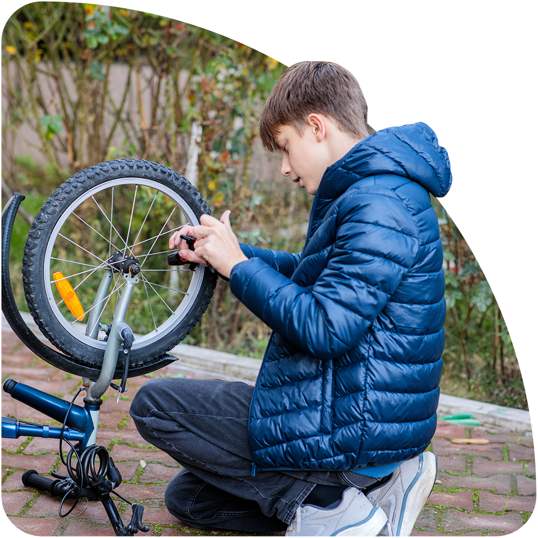 Young person fixing a bike