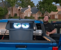 A cartoonish robot face on a trash bin called Feed Mr. Trashy™ resembling a chill person.
