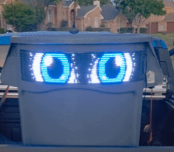 A trash bin called Feed Mr. Trashy™ with animated LED eyes on the lid, resembling a robotic face.