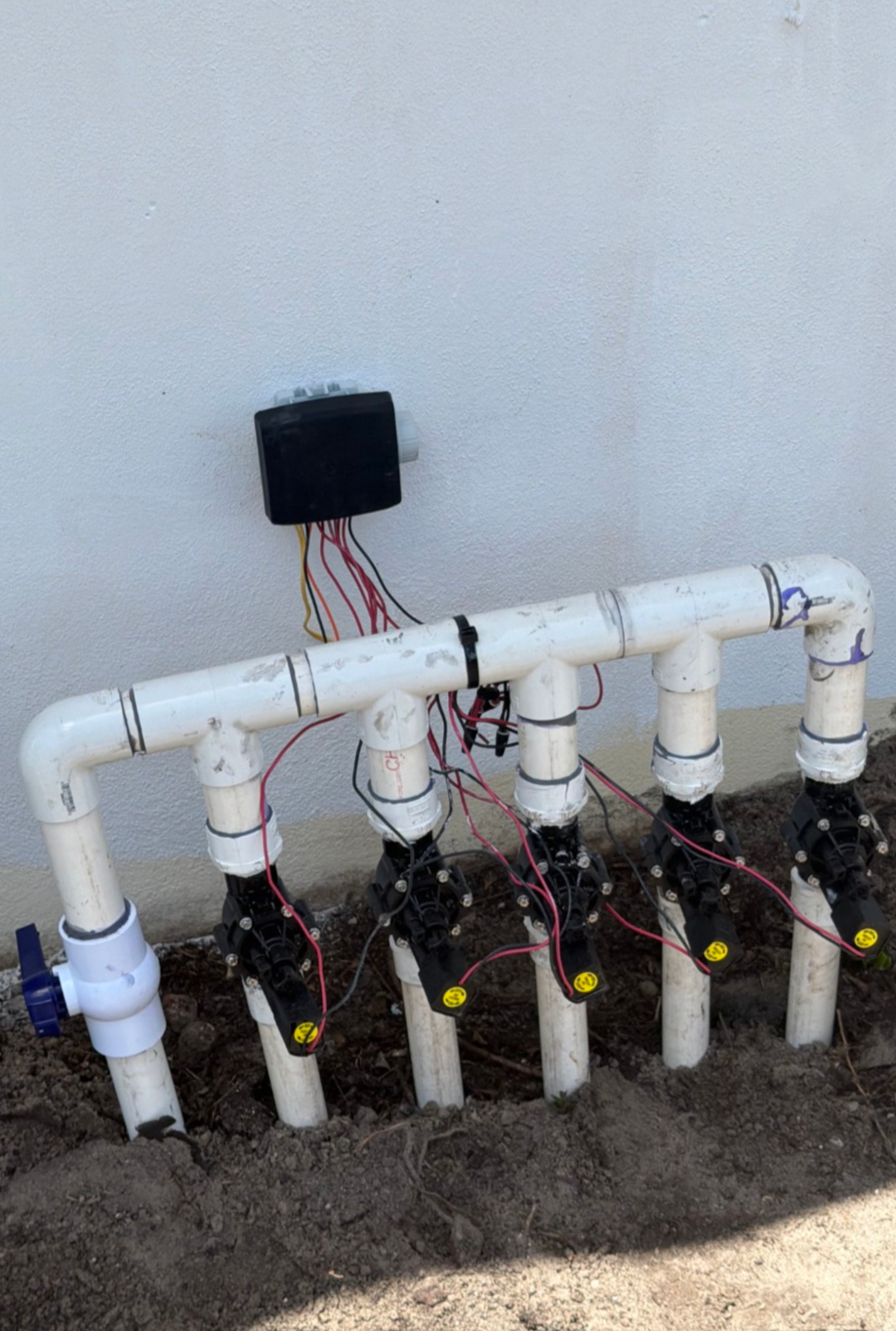 Sprinkler valves connected to a battery operated clock in a location without power.