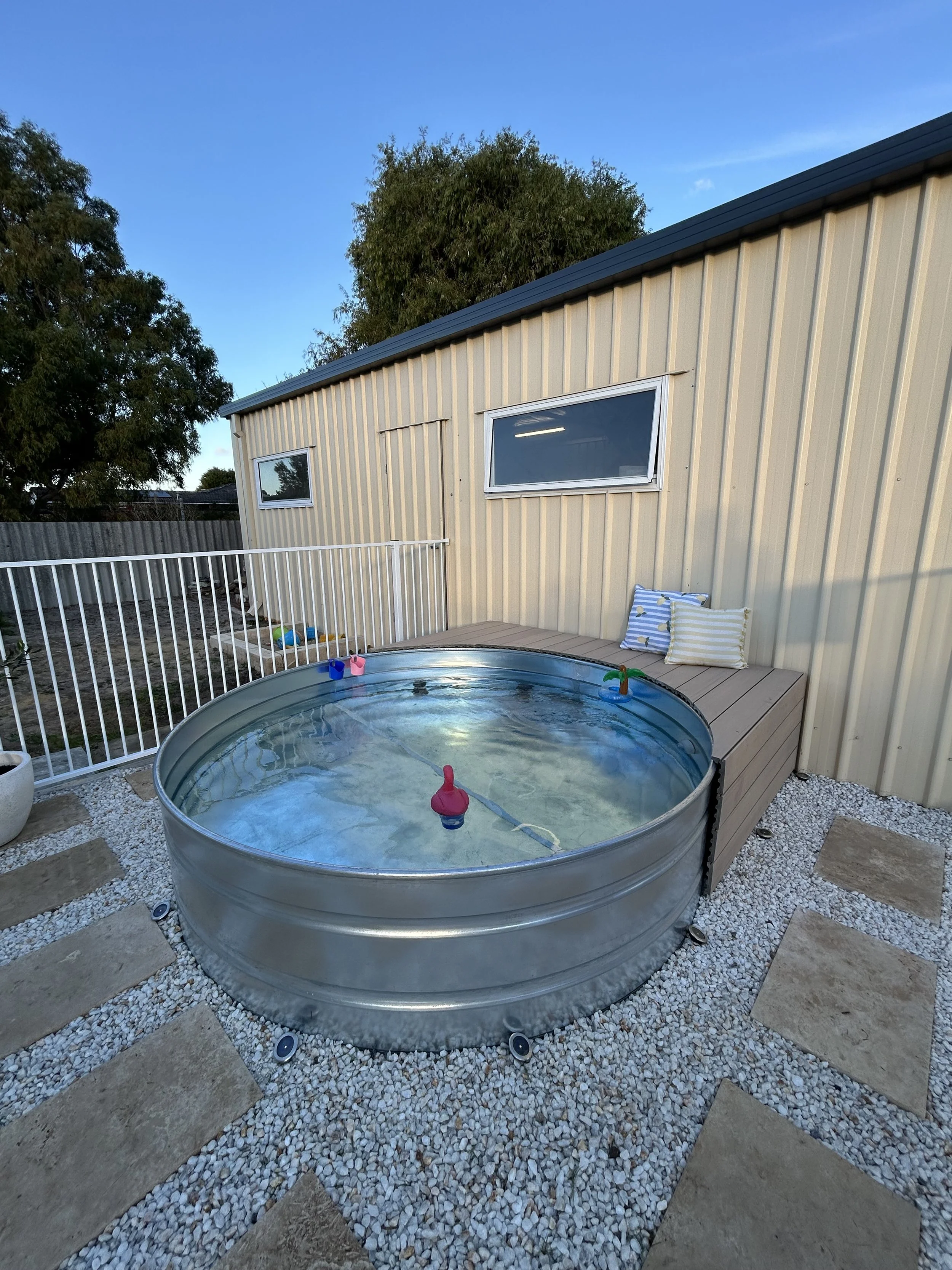 stock tank pool and small deck around half of it.