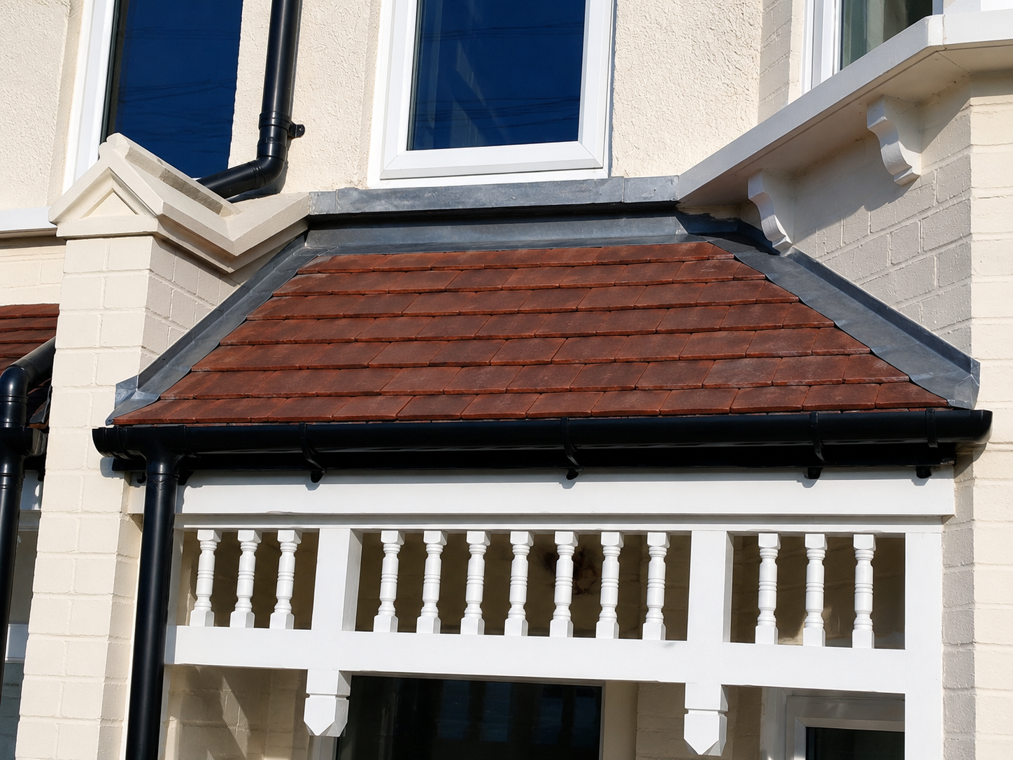 Roof repair contractor replacing damaged roof tiles on a property in West London.