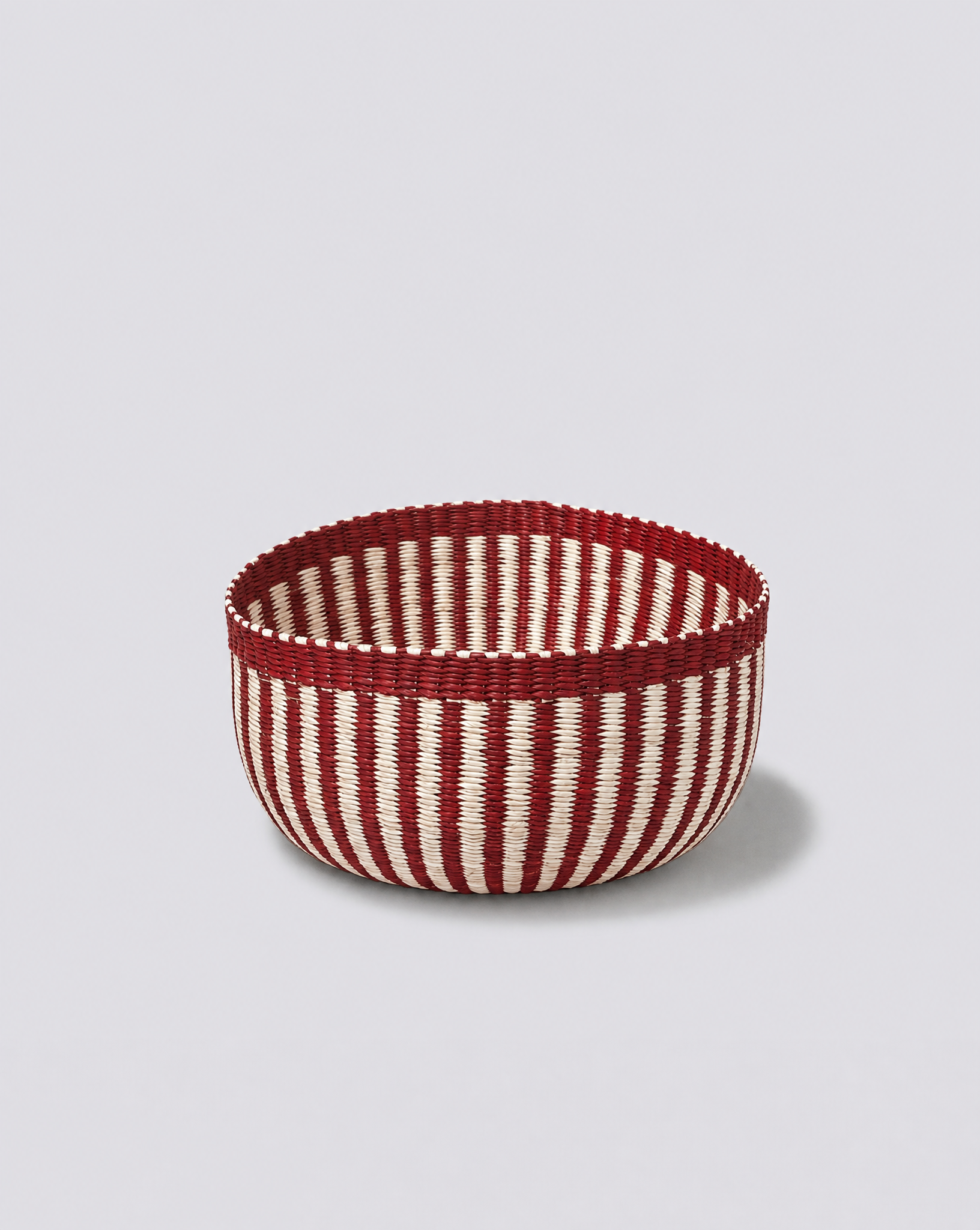 Generated with Kive.ai - Recreate this image but with these colorsStriped woven basketKeep the light and background of the image 1.png