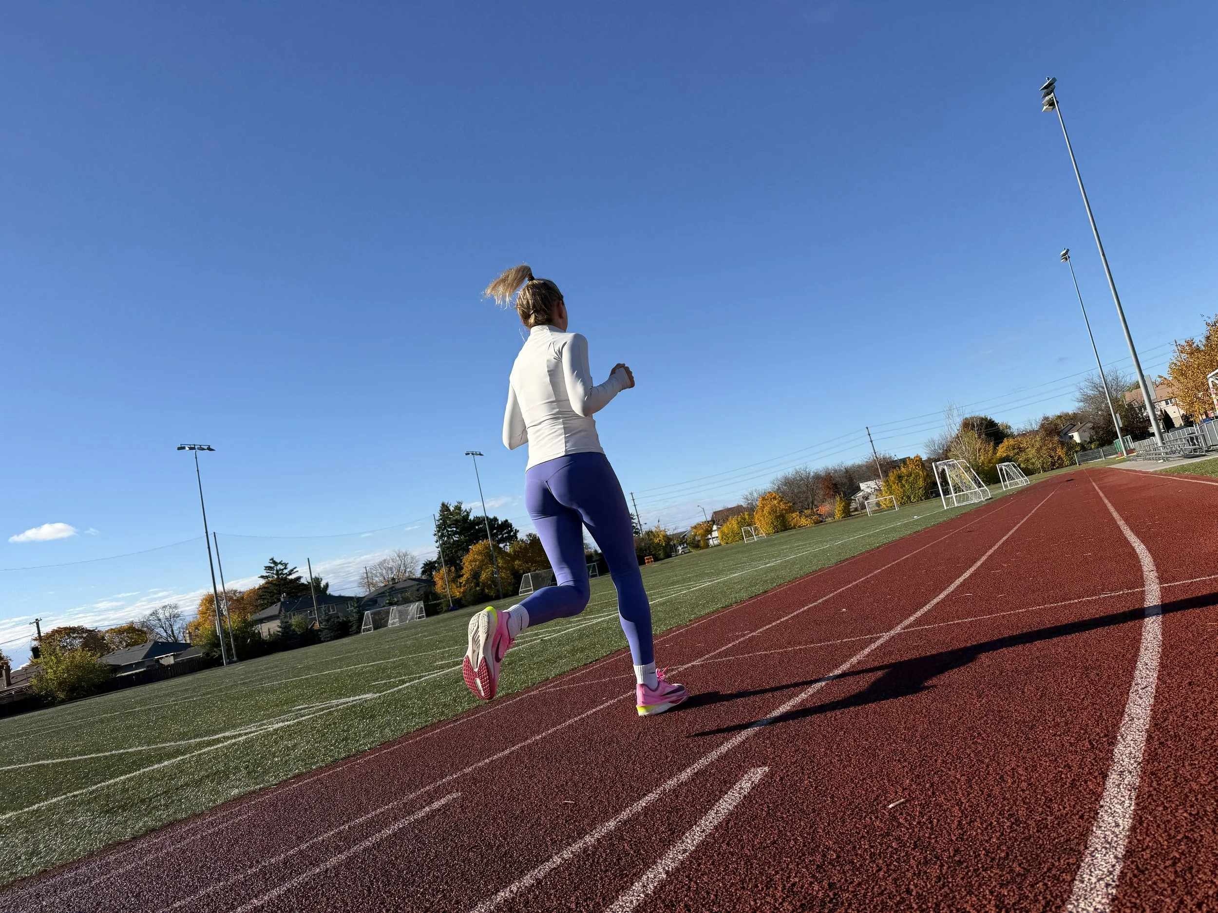 Triathlon coach supporting an age-group athlete before an endurance event.