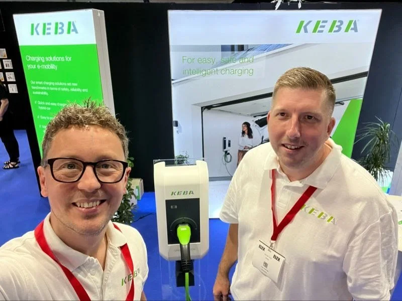 Tristan Dorman and a colleague on a KEBA EV charging exhibition stand