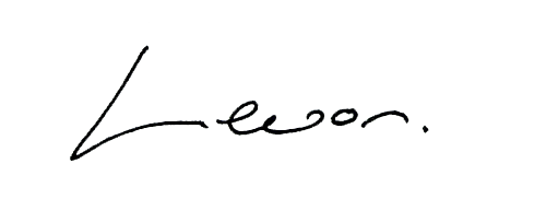 Close-up of cursive handwriting spelling 'Leo' on a black background.