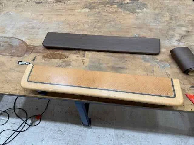 A ping pong paddle and a wooden chess or backgammon board on a workbench.