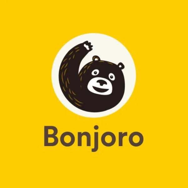 A yellow background with a cartoon bear waving, and the text 'Bonjaro' underneath.