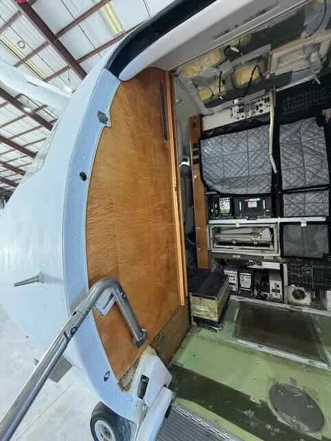 Inside a medical ambulance, featuring a wooden countertop and medical equipment.