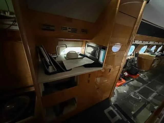 Inside the cockpit of an airplane, showing part of the control panel, a laptop, and other equipment.