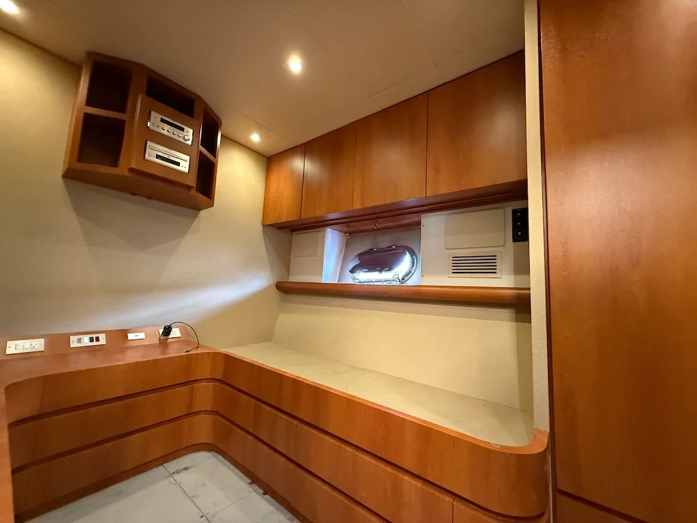Interior of a room with wooden cabinetry, a small window, and electrical outlets.