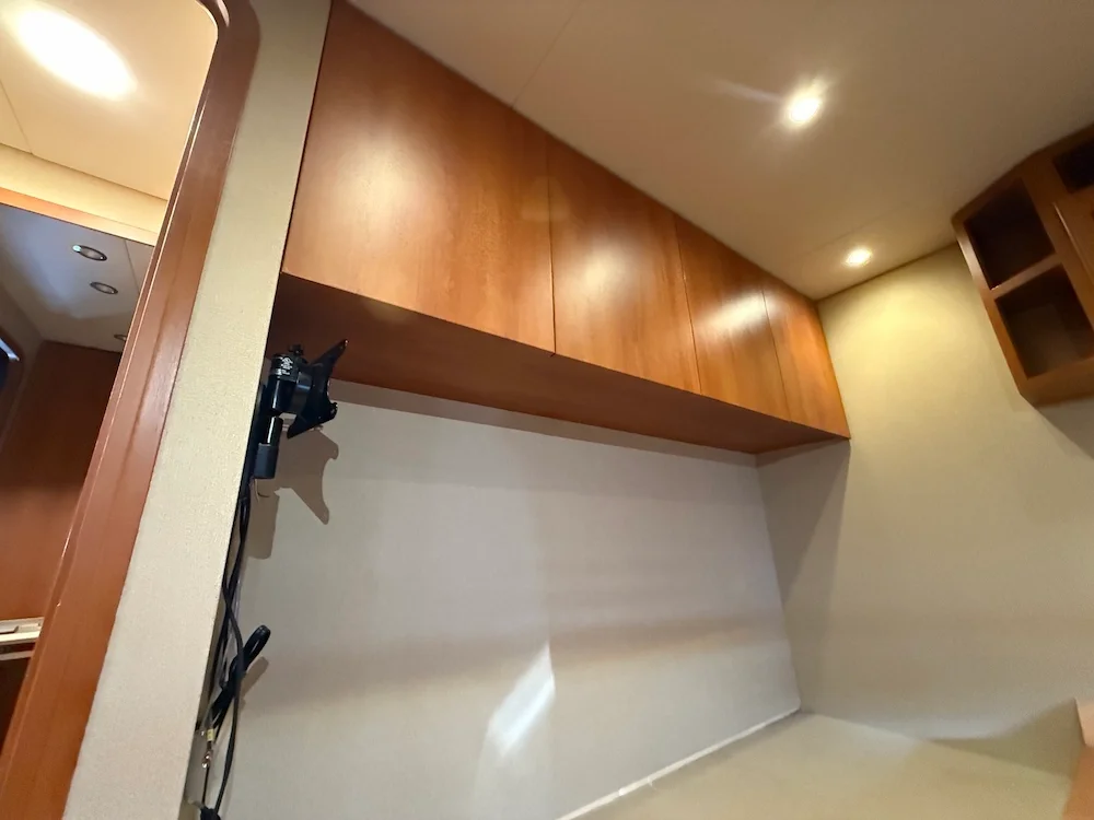 Wooden cabinets and a blank wall in a kitchen or office space.
