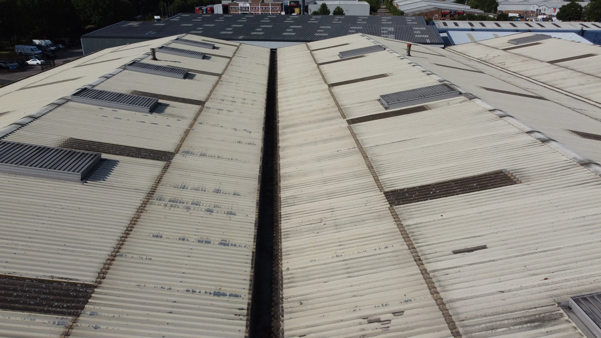 An aerial view of an industrial paper warehouse undergoing a roof inspection for guttering and steelwork.