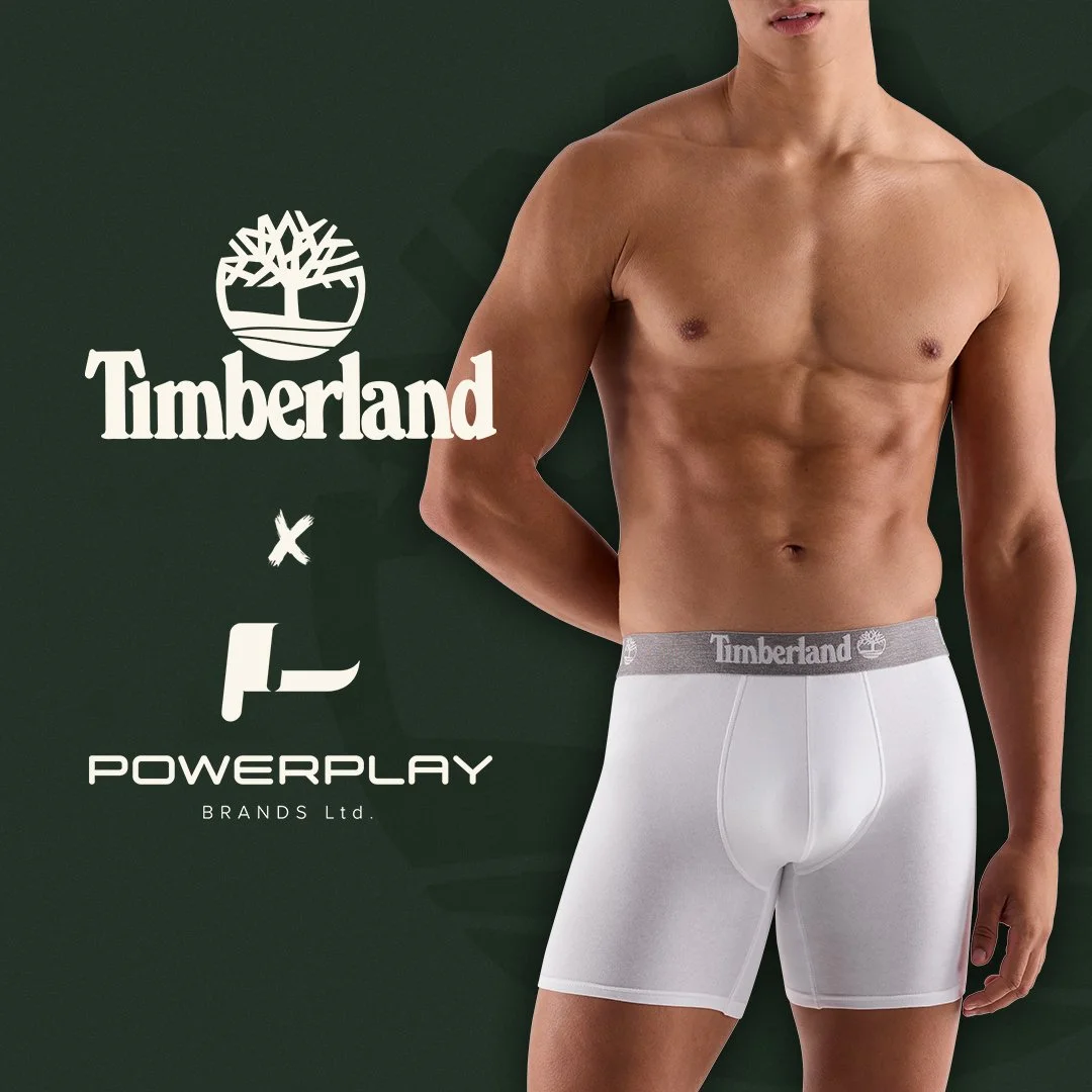 A shirtless man wearing white Timberland branded boxer shorts standing in front of a green background with Timberland and Powerplay logos.
