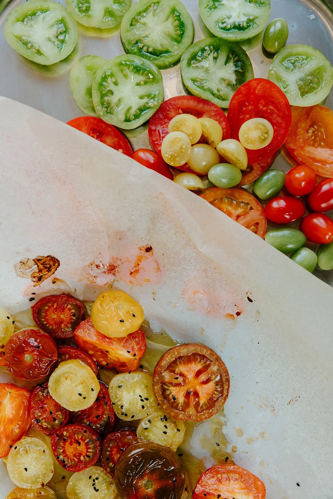 A plate of brightly coloured roasted and fresh tomatoes on a platter