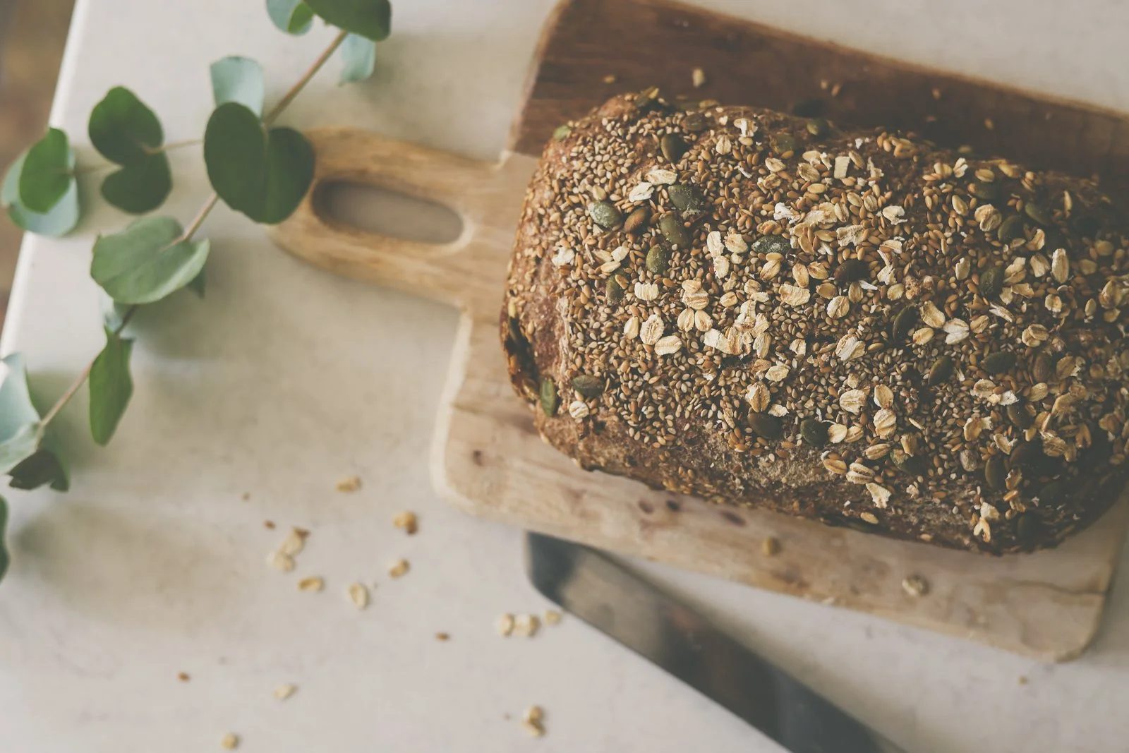 A loaf of freshly baked sourdough bread on a chopping board