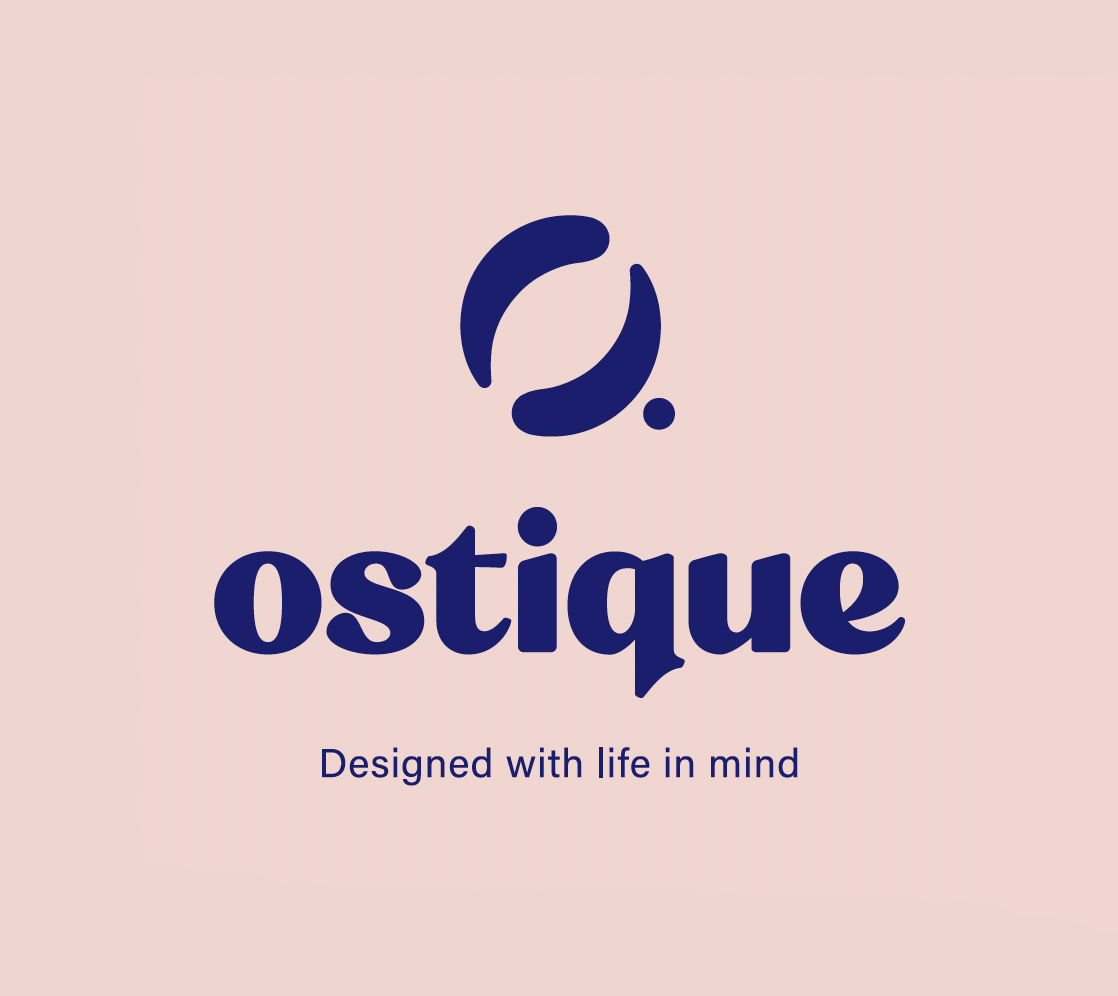 Light pink background with a navy blue logo resembling a stylized leaf or abstract shape above the word "ostique" in bold navy blue font. Below is the tagline "Designed with life in mind."