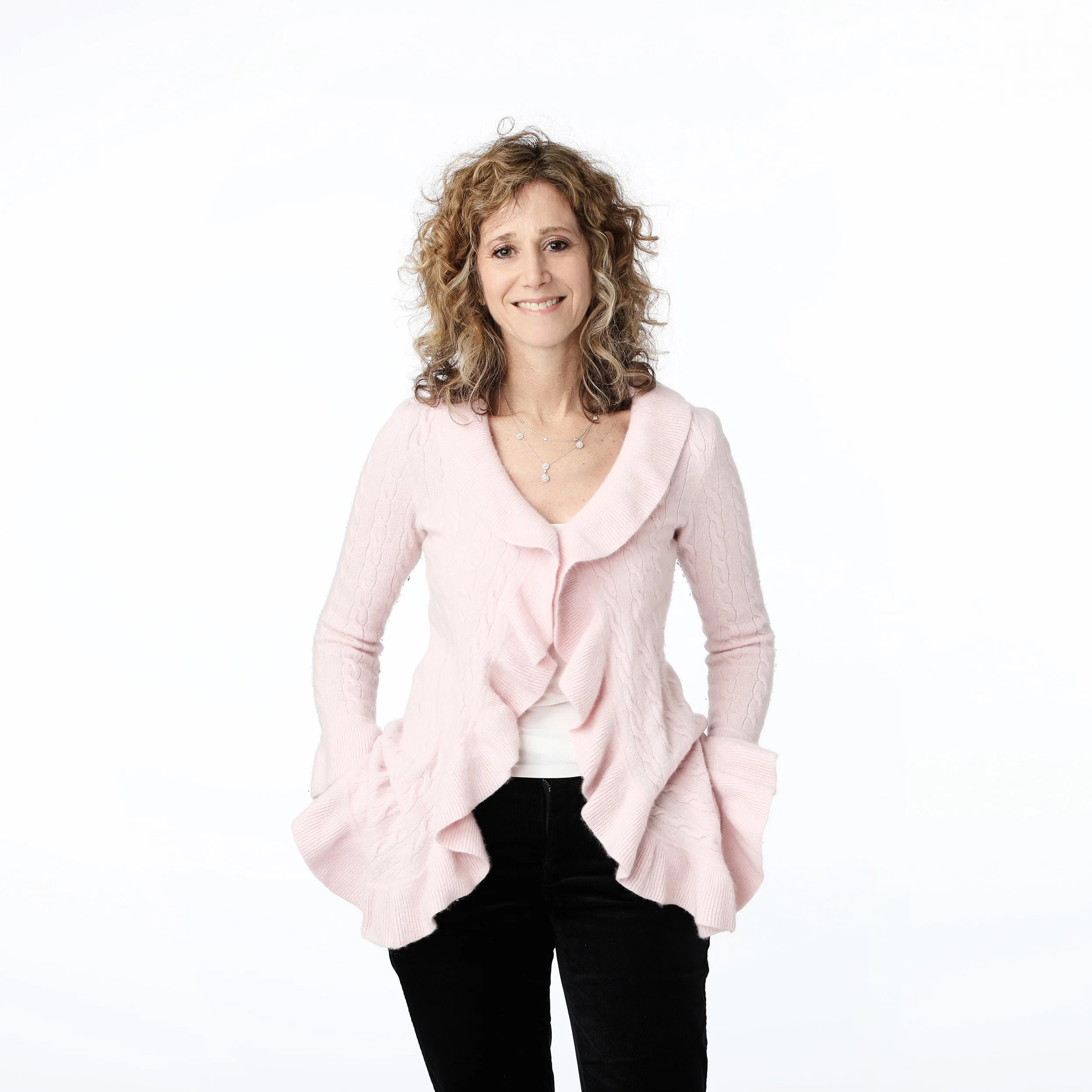 Emily, therapist, wearing a ruffle sweater, smiling