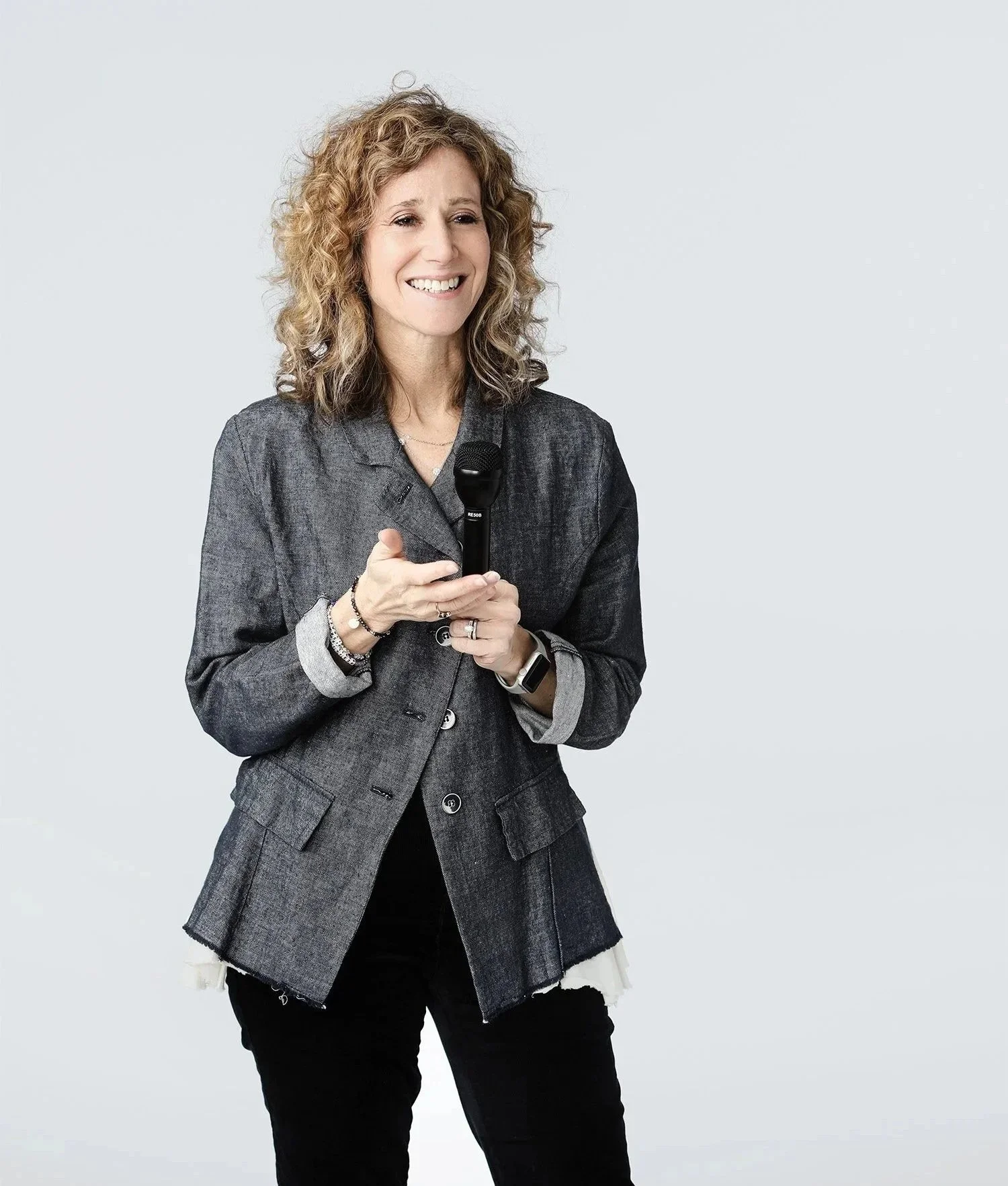 Dr Emily holding a microphone, as if she's presenting a therapy workshop n-workshops