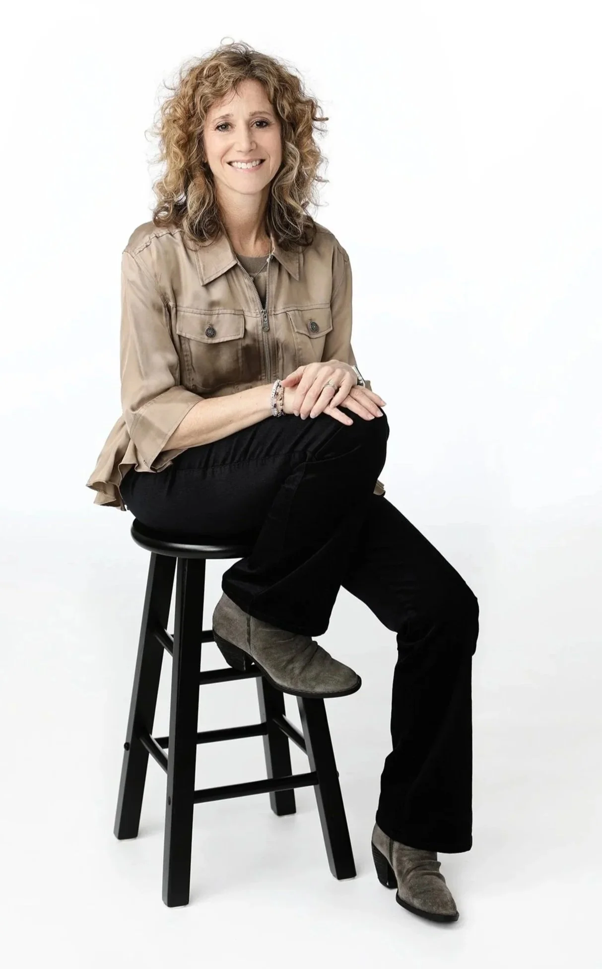 Dr Emily Gordon, psychologist, sitting on a stool, smiling