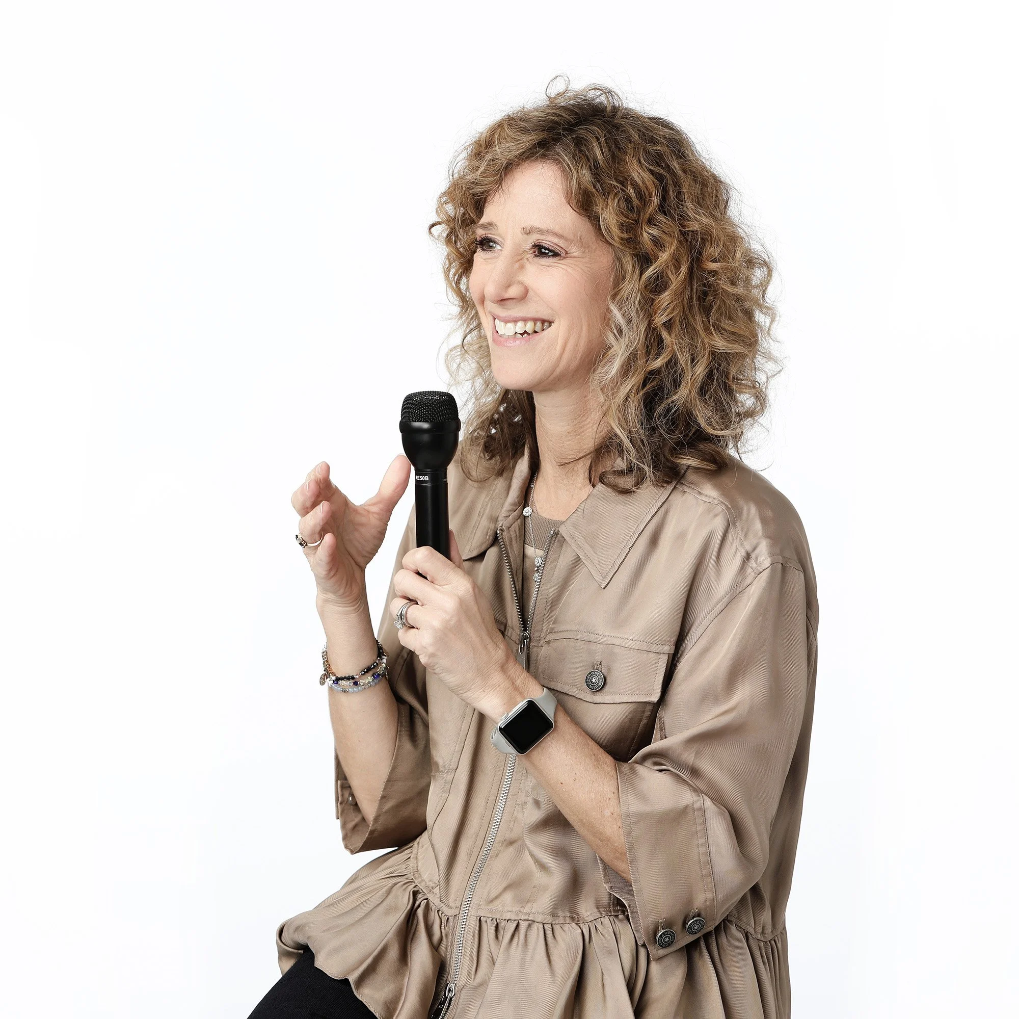 Dr Emily holding a microphone as a keynote speaker