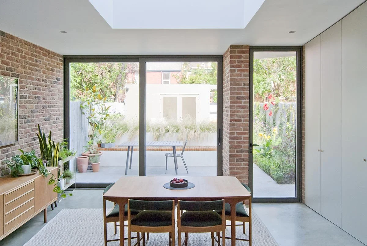 Modern home overlooking a landscaped private garden with planting and outdoor living space.
