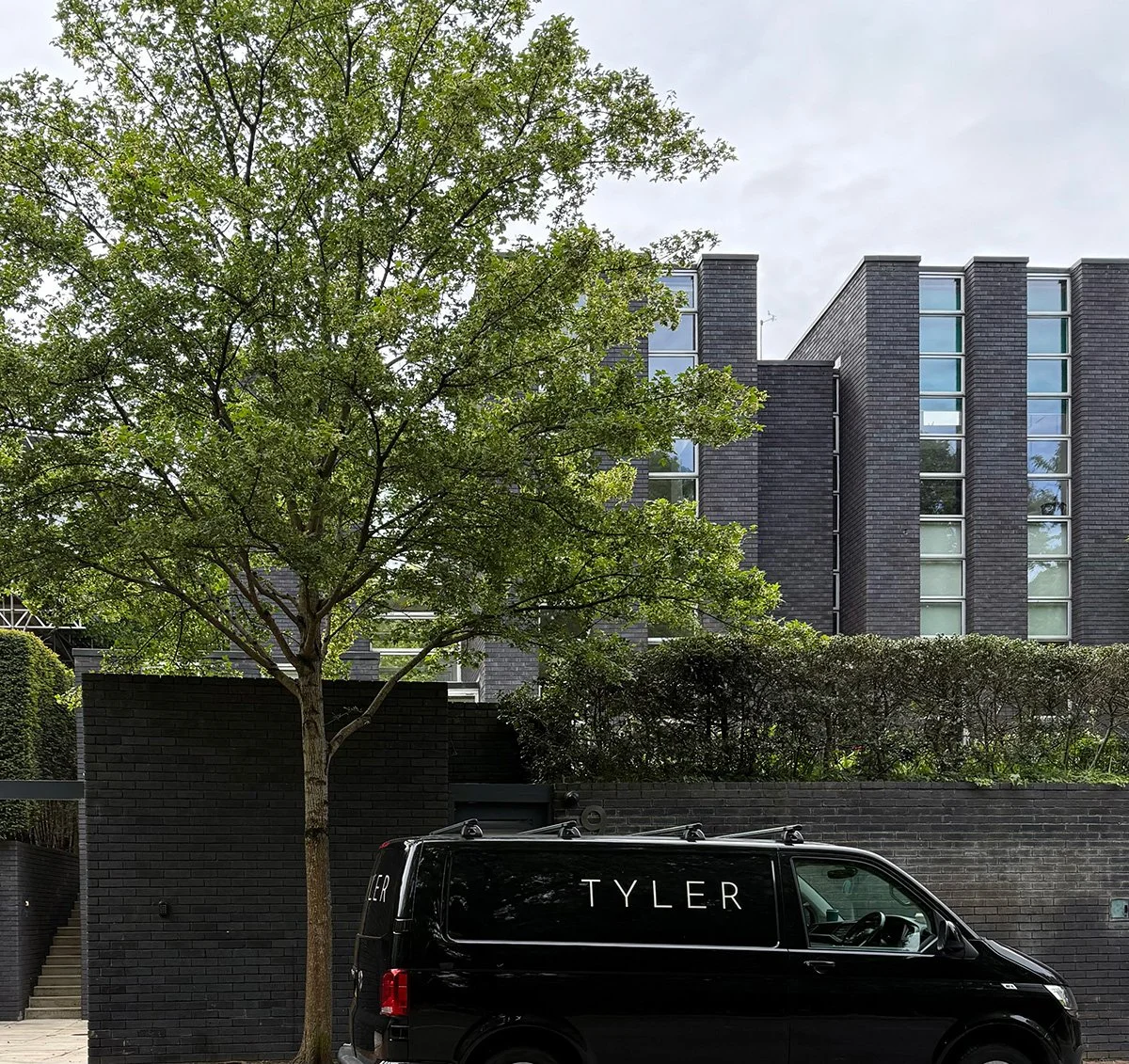 TYLER garden management van visiting a private garden in London for horticultural services.