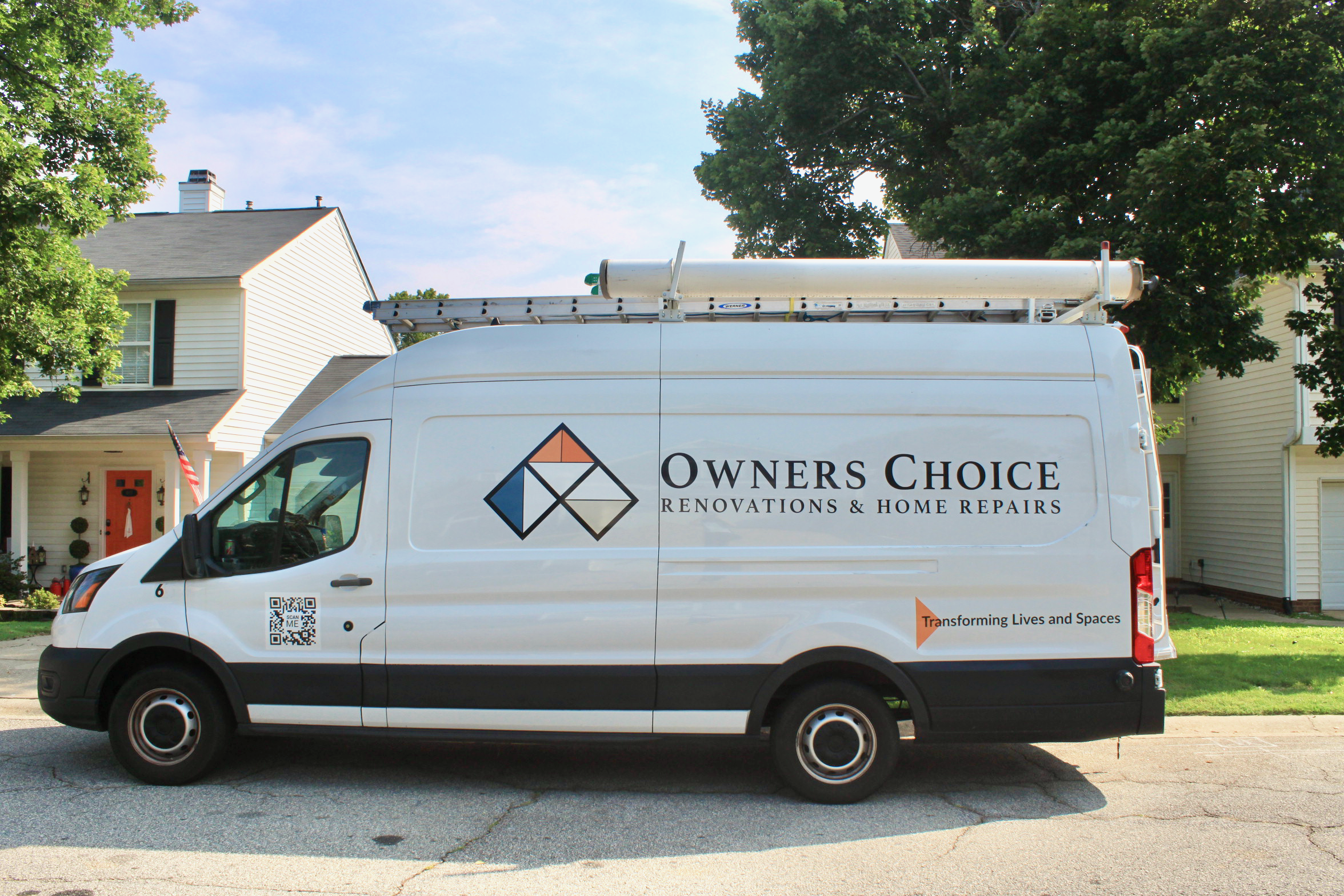 A white service van parked on a residential street, with trees and houses in the background. The van has a ladder on top and features the logo and name 'Owners Choice Renovations & Home Repairs' on its side.