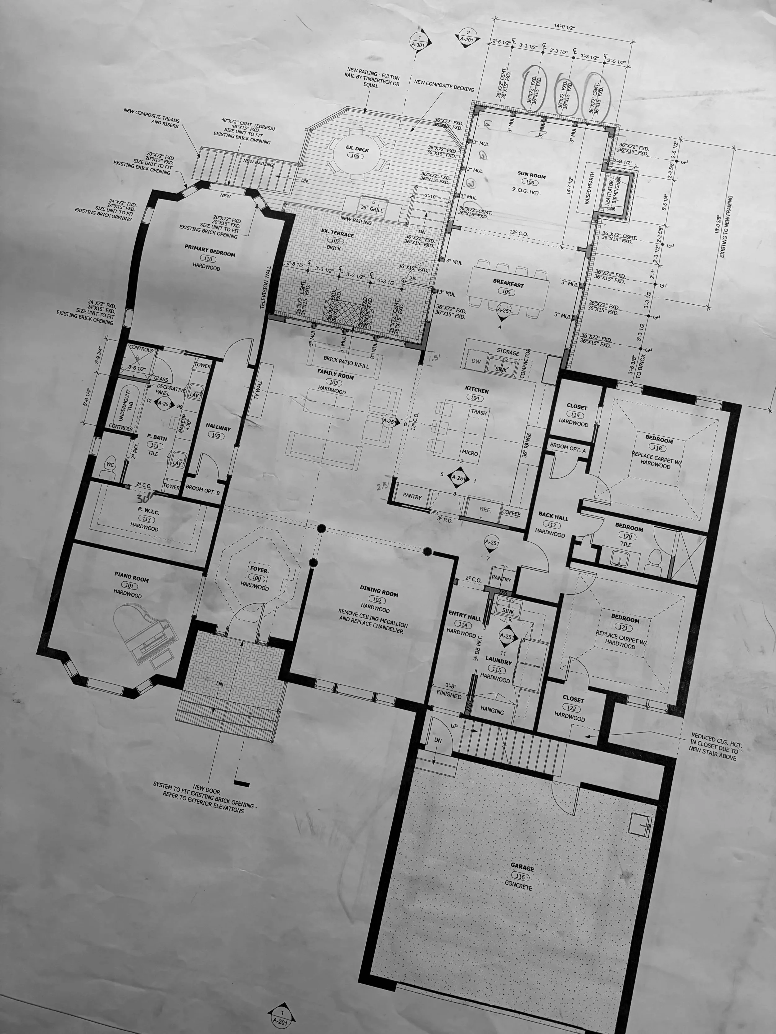 Architectural floor plan of a house showing various rooms including primary bedroom, family room, kitchen, bedrooms, bathrooms, garage, and outdoor decks with detailed measurements and annotations.