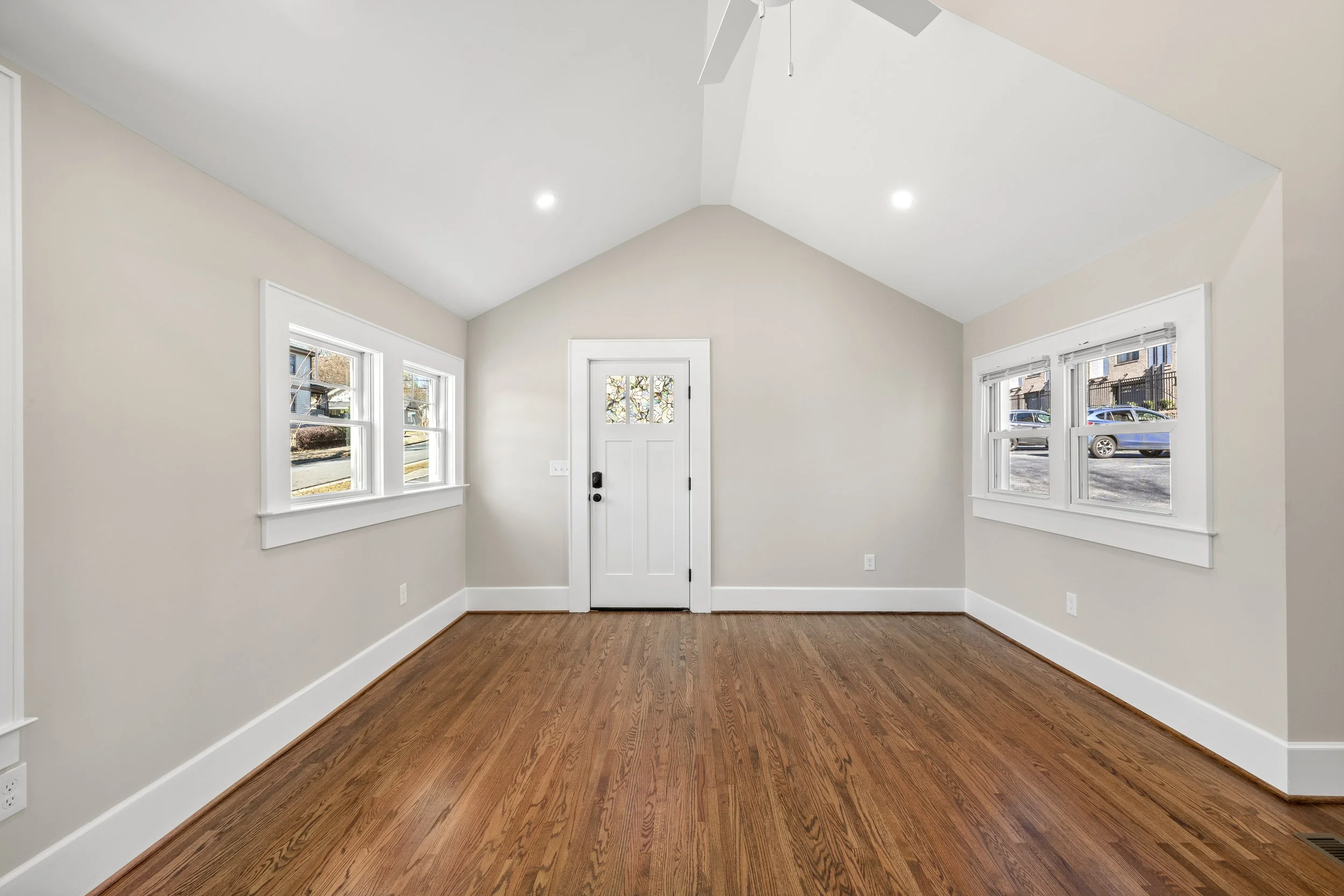 A repaired and repainted empty living room with new wood floors ready to be sold, in Greenville South Carolina