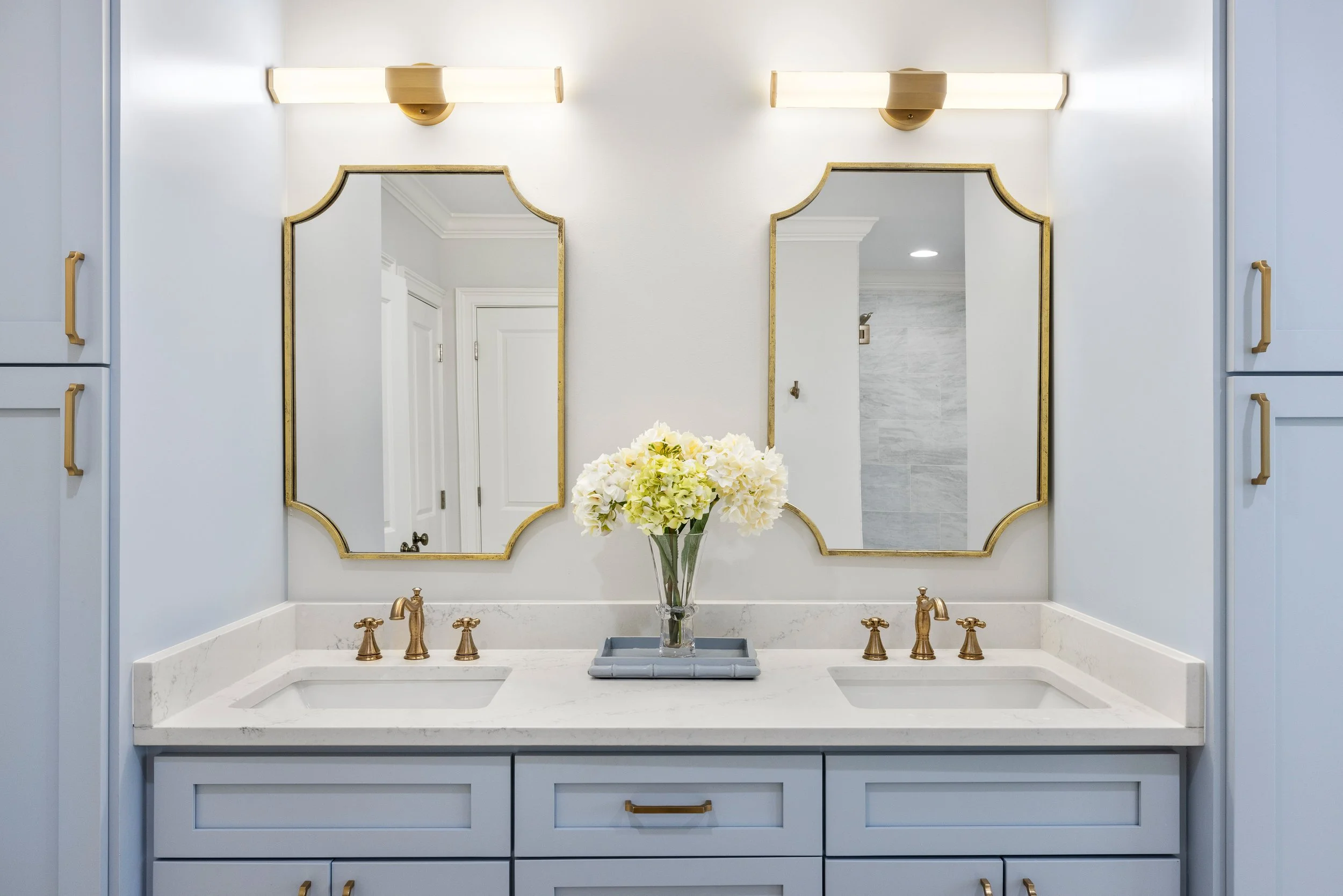 A luxury primary bathroom renovation with custom cabinets and a quartz double vanity in Greenville, South Carolina. 