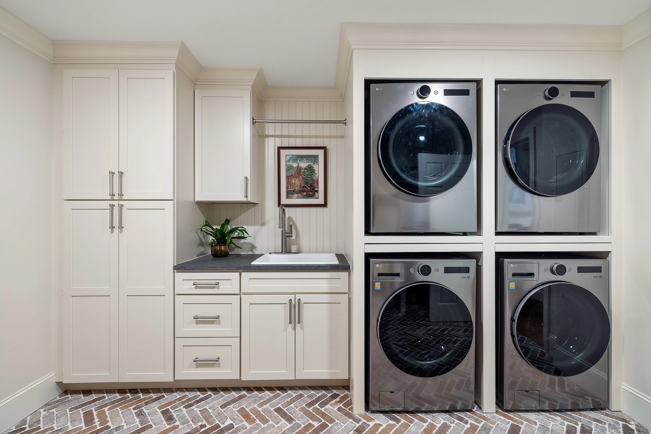 A rustic laundry room renovation with custom cabinets and brick flooring in Greenville, South Carolina