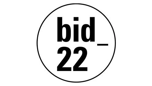 Texto en un círculo que dice 'bid_22' en letras negras.